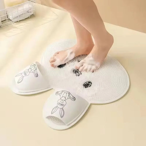 Person standing on the Footsly silicone shower mat, cleaning feet without bending over